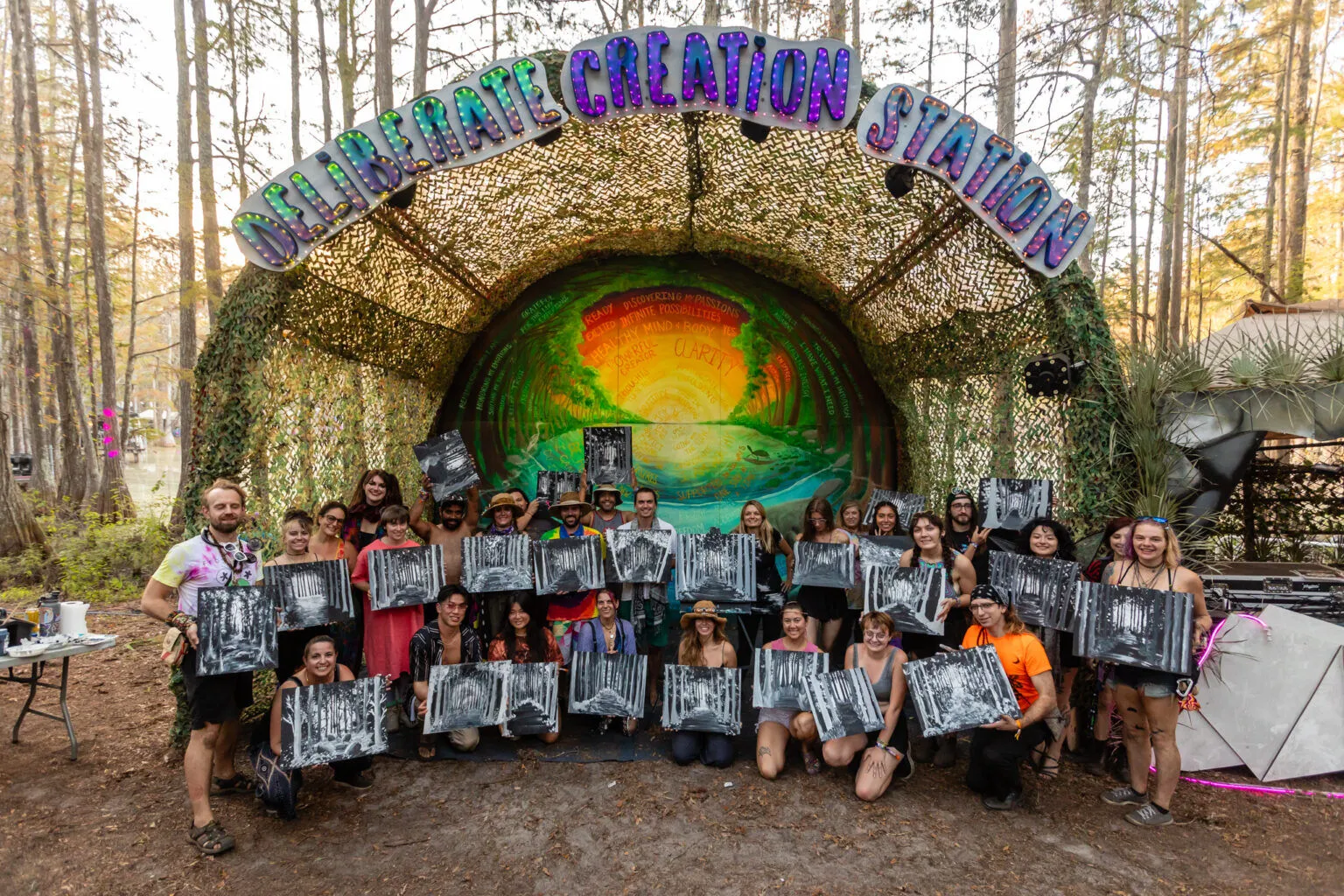 Workshop group holding up their paintings