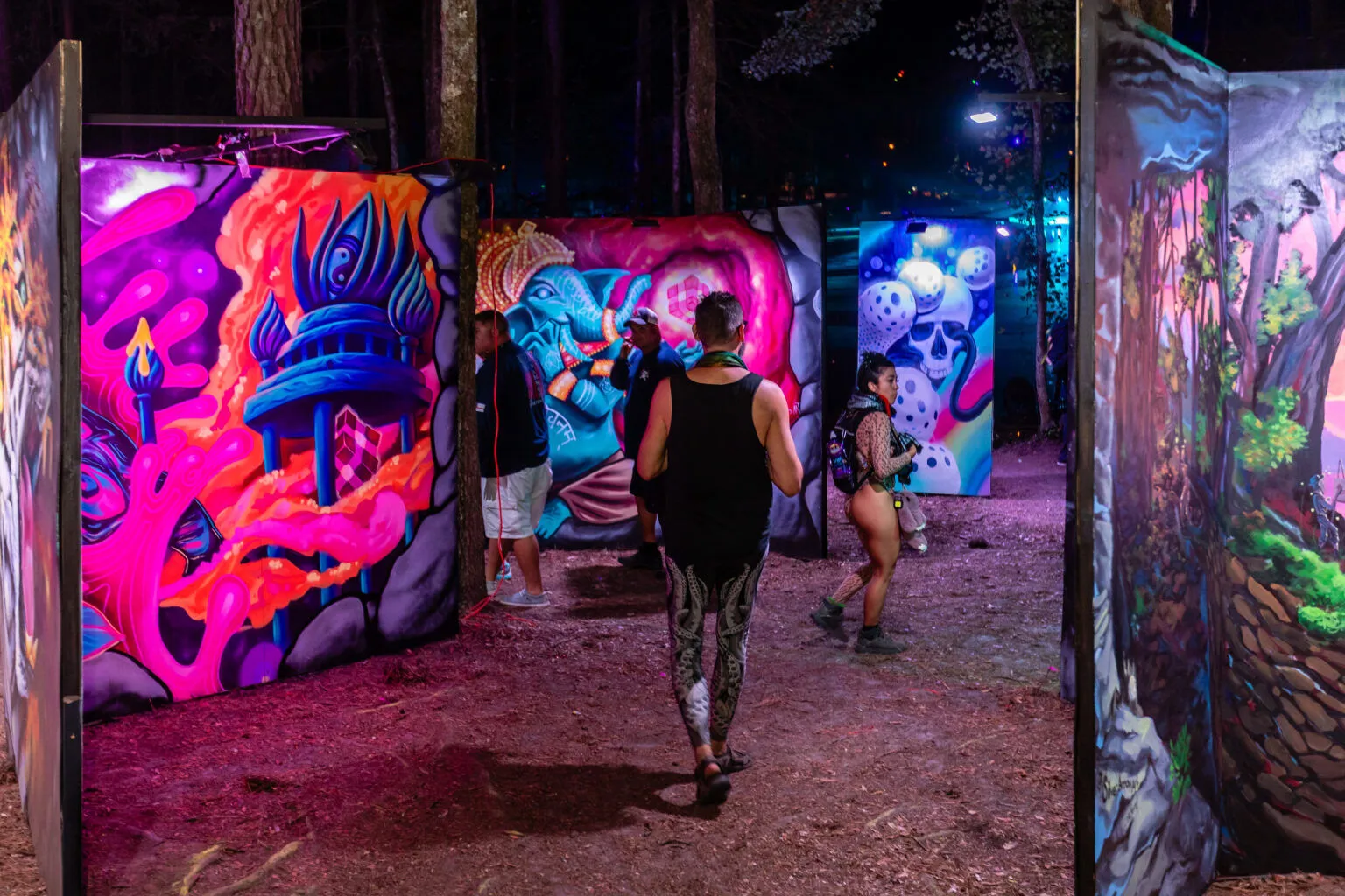 Visitors walking the Mural Maze at night